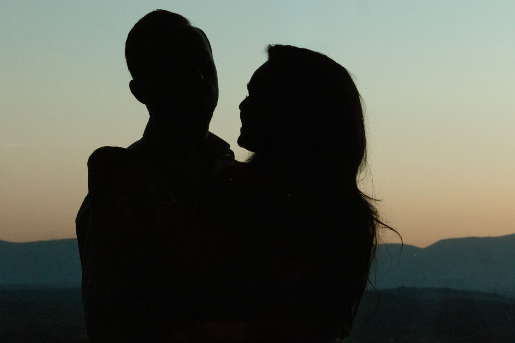 Silhouette of a couple against a sunset backdrop captured during their reception at Klocke Estate Brewery in Hudson, NY. 